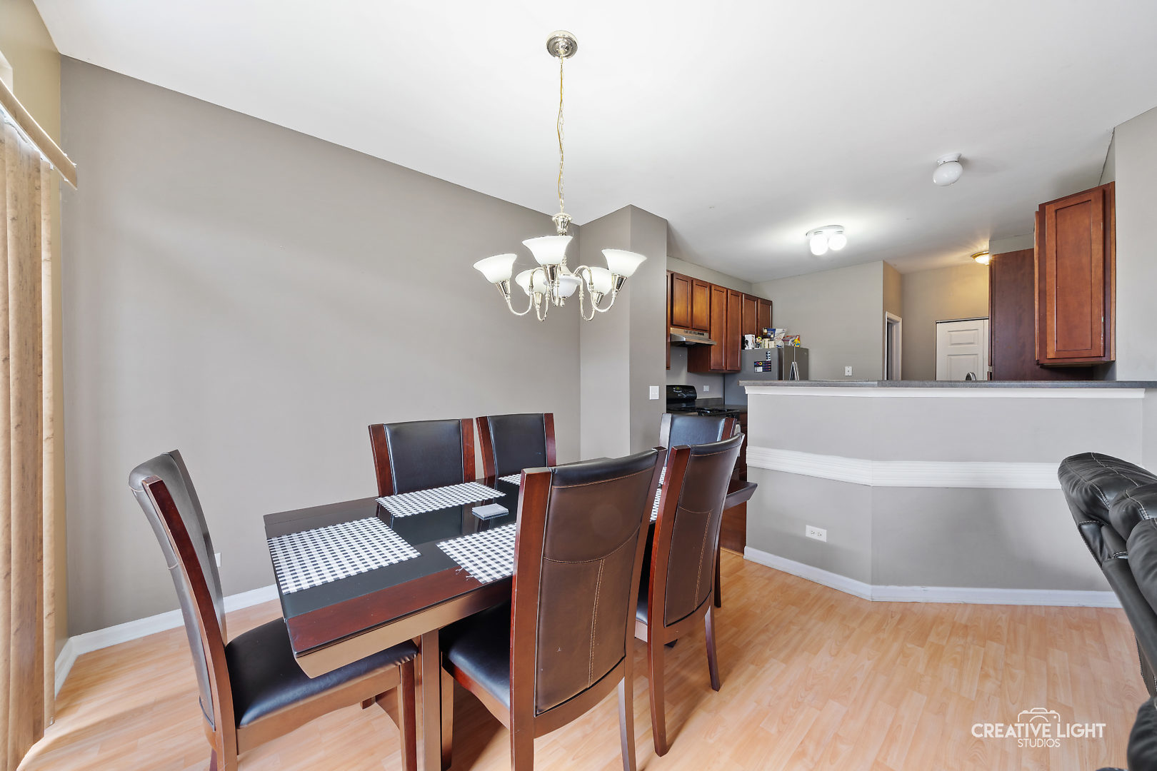 1987 West Cobblestone Road Romeoville, IL 60446 - Photo 7 of 20 a dining room with furniture a chandelier and window