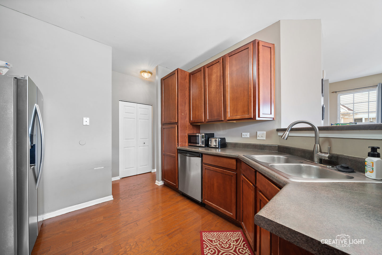 1987 West Cobblestone Road Romeoville, IL 60446 - Photo 8 of 20 a kitchen with stainless steel appliances granite countertop a sink stove and refrigerator