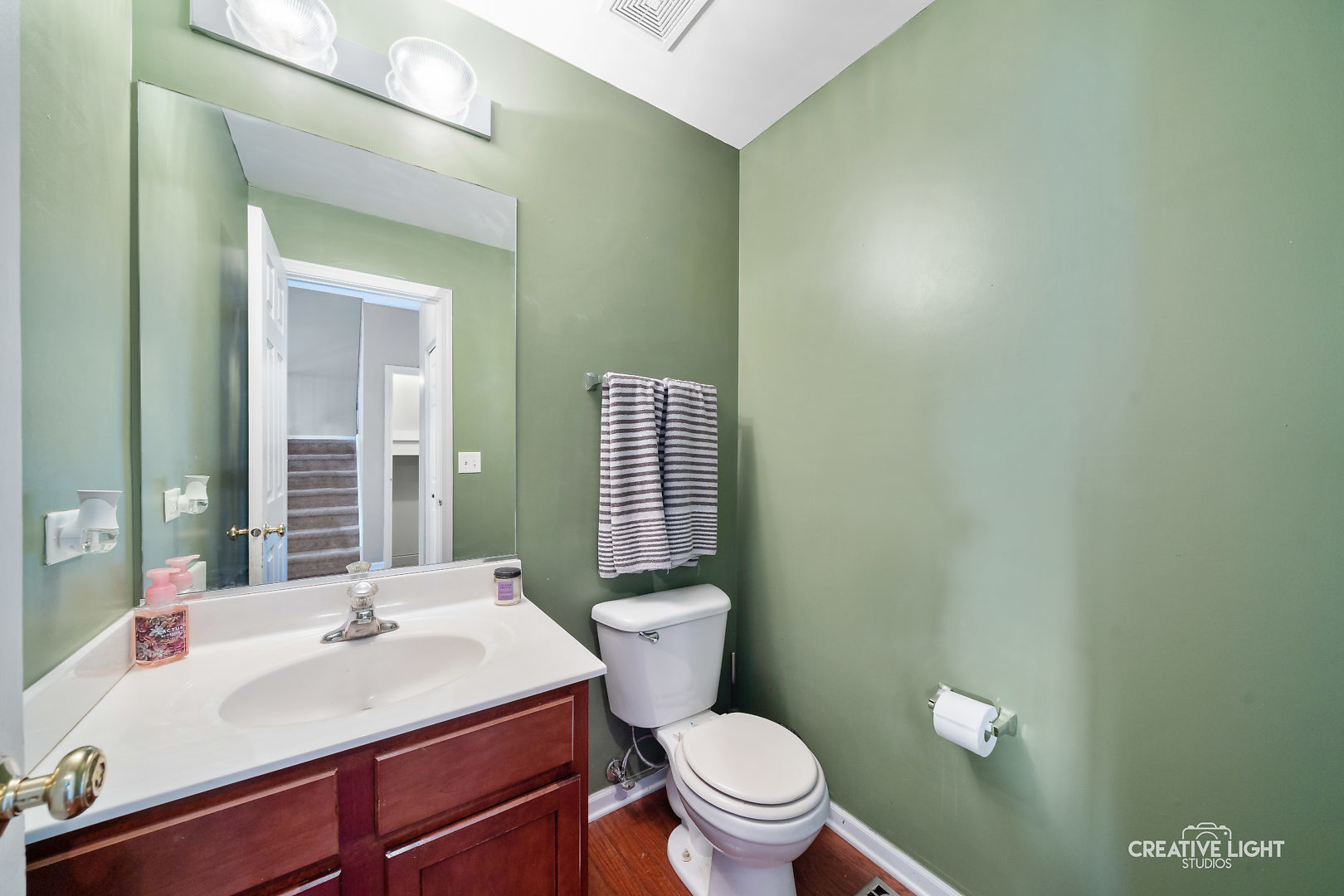 1987 West Cobblestone Road Romeoville, IL 60446 - Photo 10 of 20 a bathroom with a sink a toilet and mirror