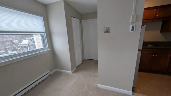 a view of an empty room and a window