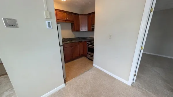 a kitchen with a refrigerator and a stove