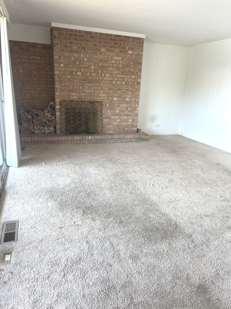 1601 Maple Terrace, Unit 3B Lisle, IL 60532 - Photo 6 of 9 a view of an empty room and fire place