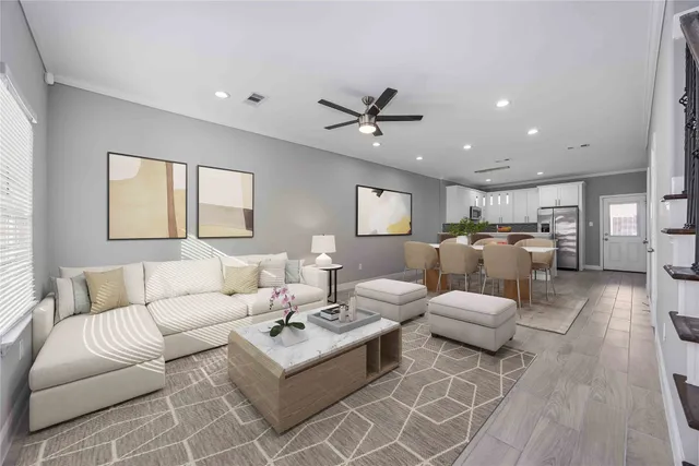 a living room with furniture and a wooden floor