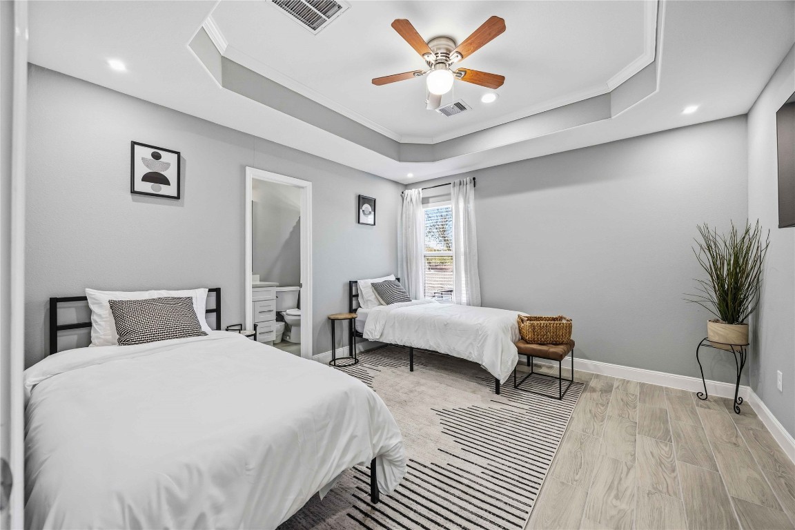 4903 Mallow Street, Unit A Houston, TX 77033 - Photo 8 of 10 a bedroom with a bed and a chandelier