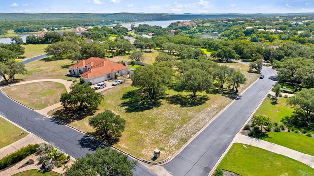 an aerial view of a house with a yard