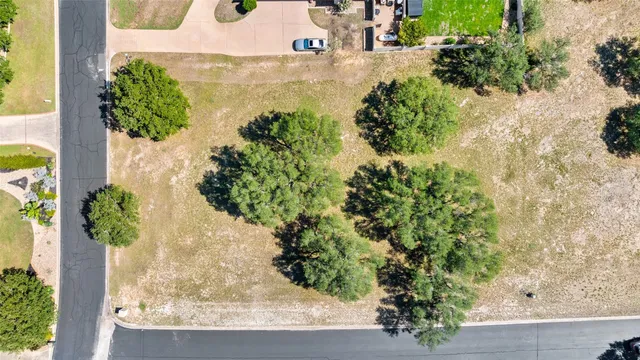 an aerial view of residential houses with outdoor space and river