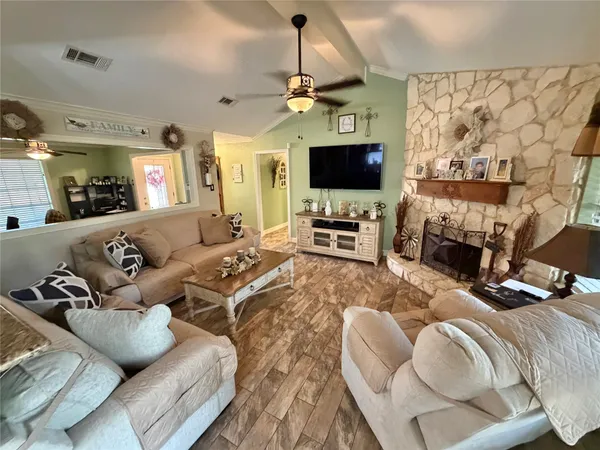 a kitchen with a sink a refrigerator and cabinets