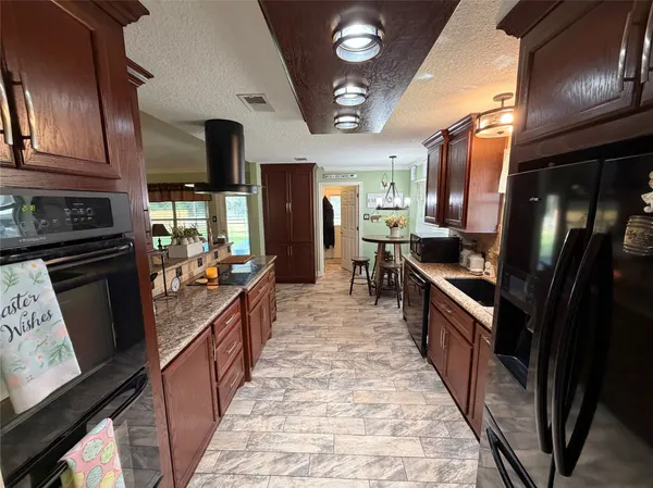 a view of a room with furniture and wooden floor
