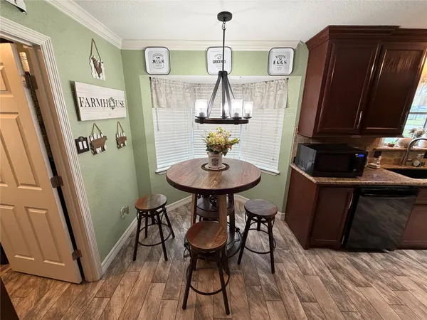 a view of a room with furniture and wooden floor