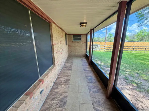 a view of a house with a yard garage and a large tree