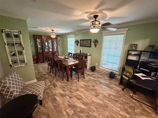 a view of a dining room with furniture and wooden floor