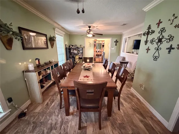 a view of a dining room with furniture and wooden floor