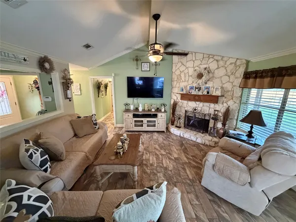 a living room with furniture fireplace and a chandelier
