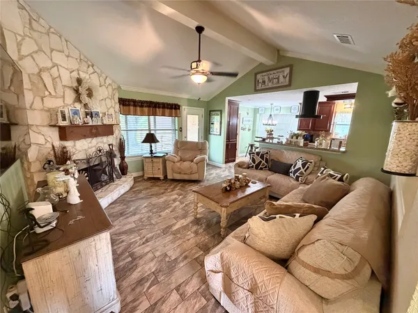 a living room with furniture a flat screen tv and a fireplace