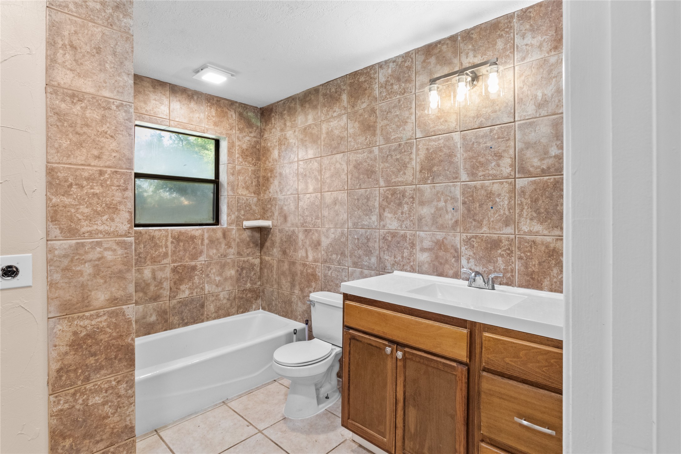 4201 Sevan Street Bacliff, TX 77518 - Photo 7 of 22 a bathroom with a granite countertop bathtub sink vanity mirror and toilet