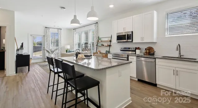 a kitchen with a sink stove and microwave