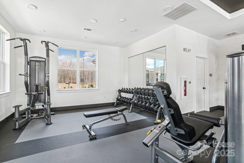 13511 Montoy Way, Unit A2 Charlotte, NC 28273 - Photo 19 of 34 a room with gym equipment and a large window