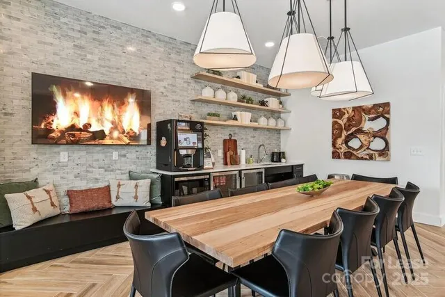 a kitchen with stainless steel appliances dining table and chairs