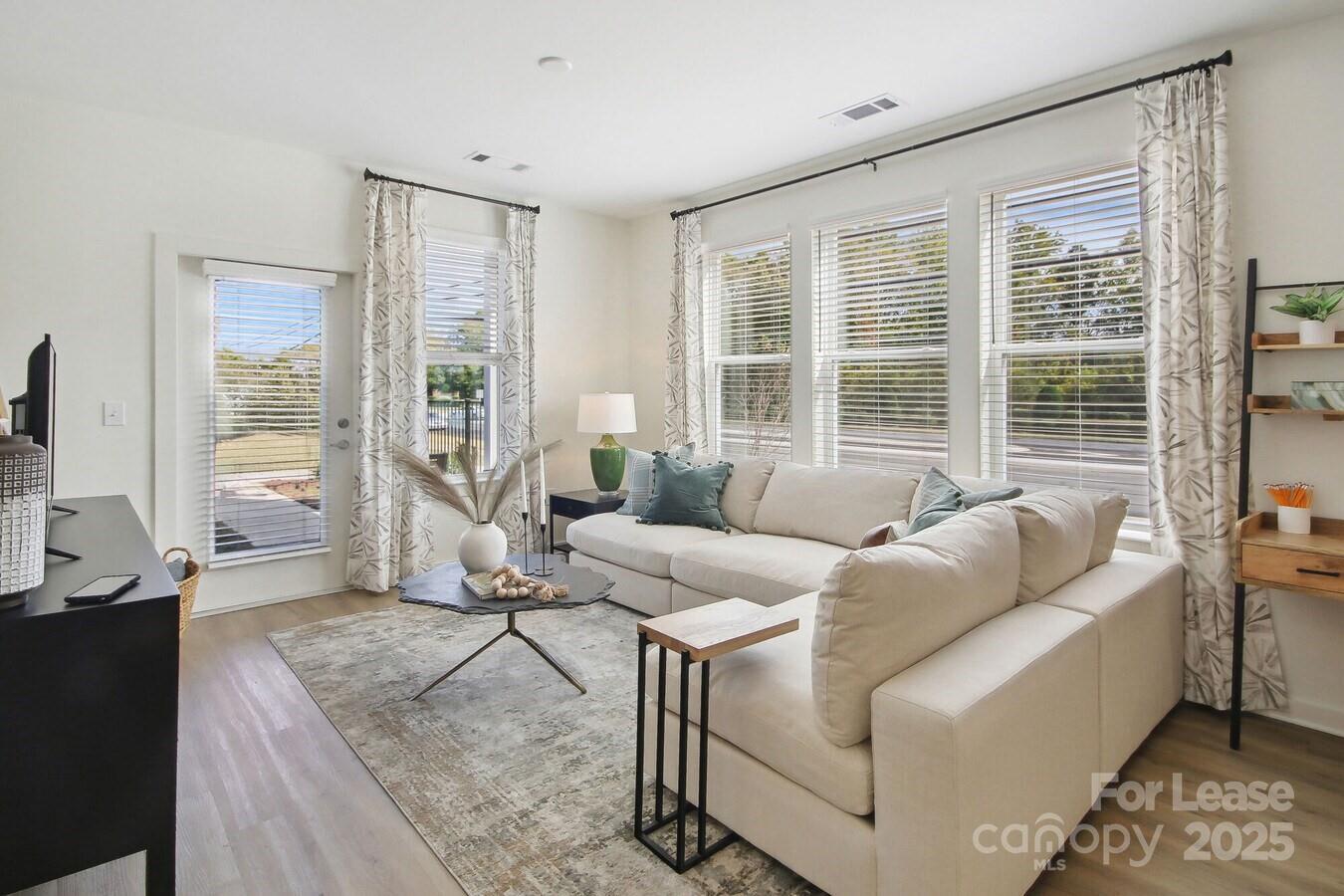 13511 Montoy Way, Unit A2 Charlotte, NC 28273 - Photo 5 of 34 a living room with furniture and a large window
