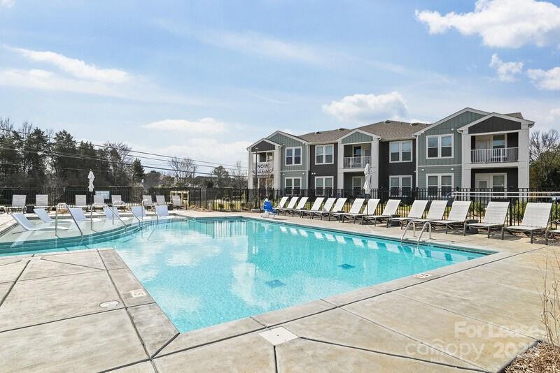 13511 Montoy Way, Unit A2 Charlotte, NC 28273 - Photo 10 of 34 a view of a patio with swimming pool table and chairs