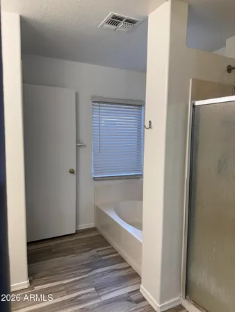 a view of an empty room with a chandelier fan