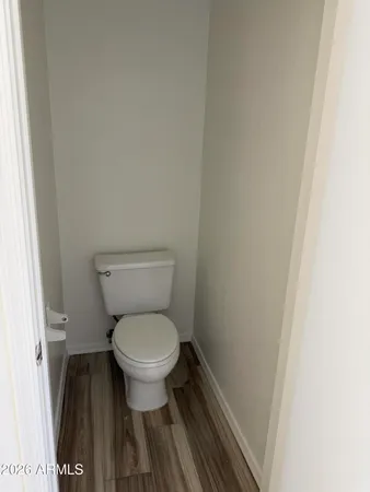 a view of a hallway with wooden floor and closet