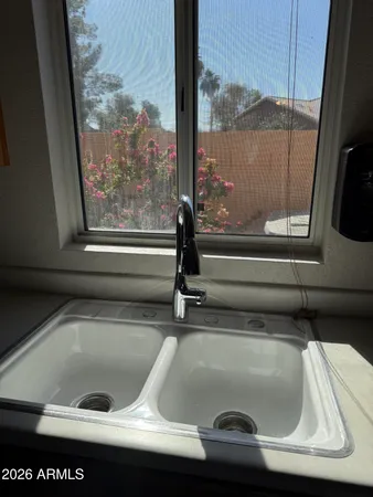a view of room with wooden floor and chandelier