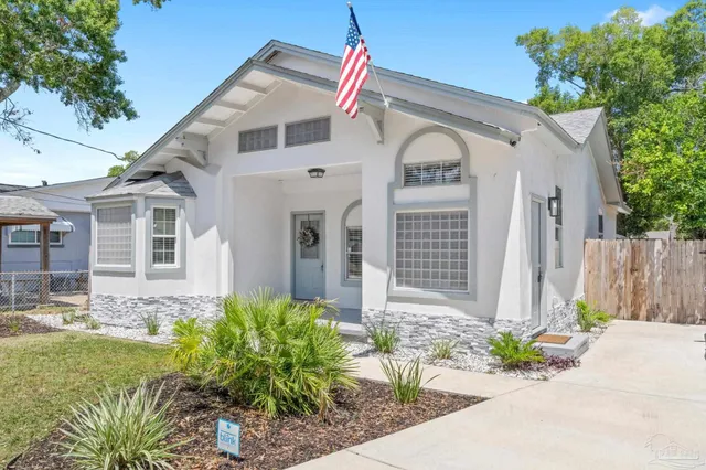 a front view of a house with a garden