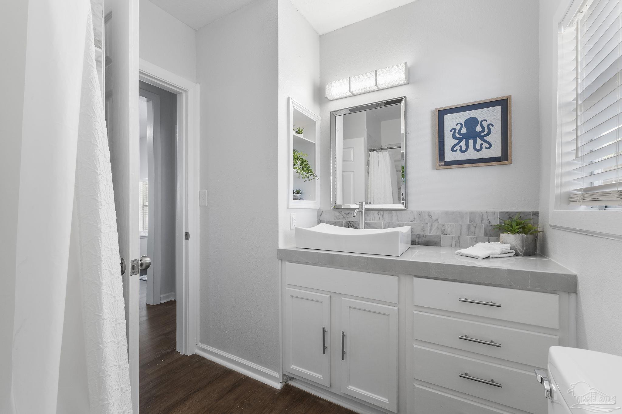 306 South N Street Pensacola, FL 32502 - Photo 19 of 37 a bathroom with a granite countertop sink and a mirror