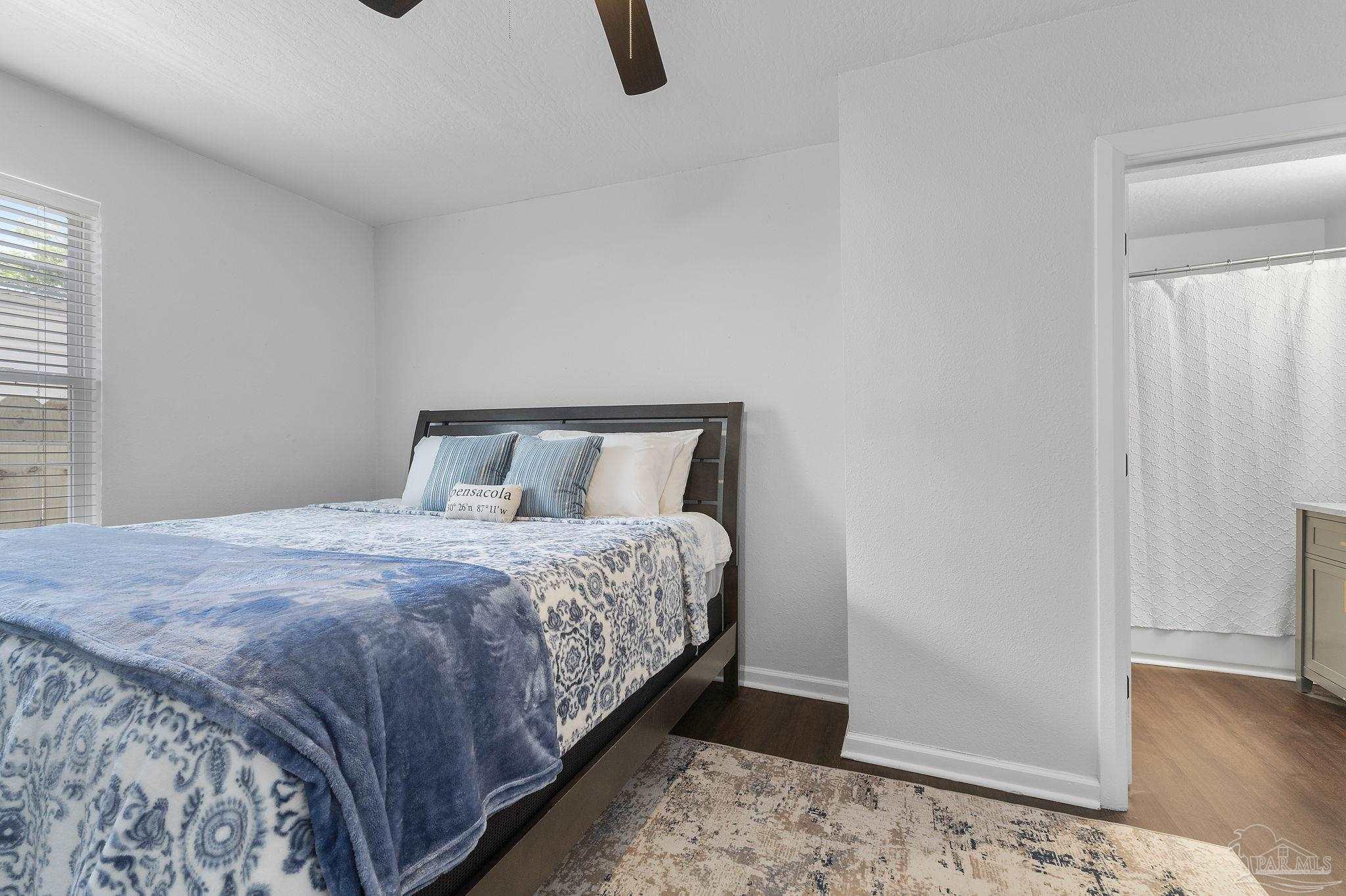 306 South N Street Pensacola, FL 32502 - Photo 20 of 37 a bedroom with a bed and wooden floor