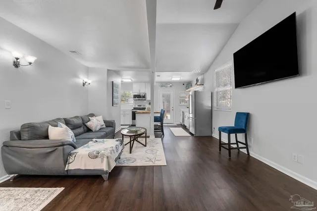 a living room with furniture and a wooden floor
