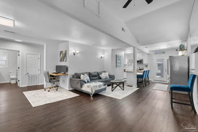 a living room with furniture and a wooden floor