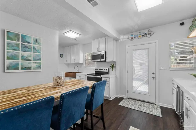 a kitchen with stainless steel appliances kitchen island granite countertop a stove and a sink