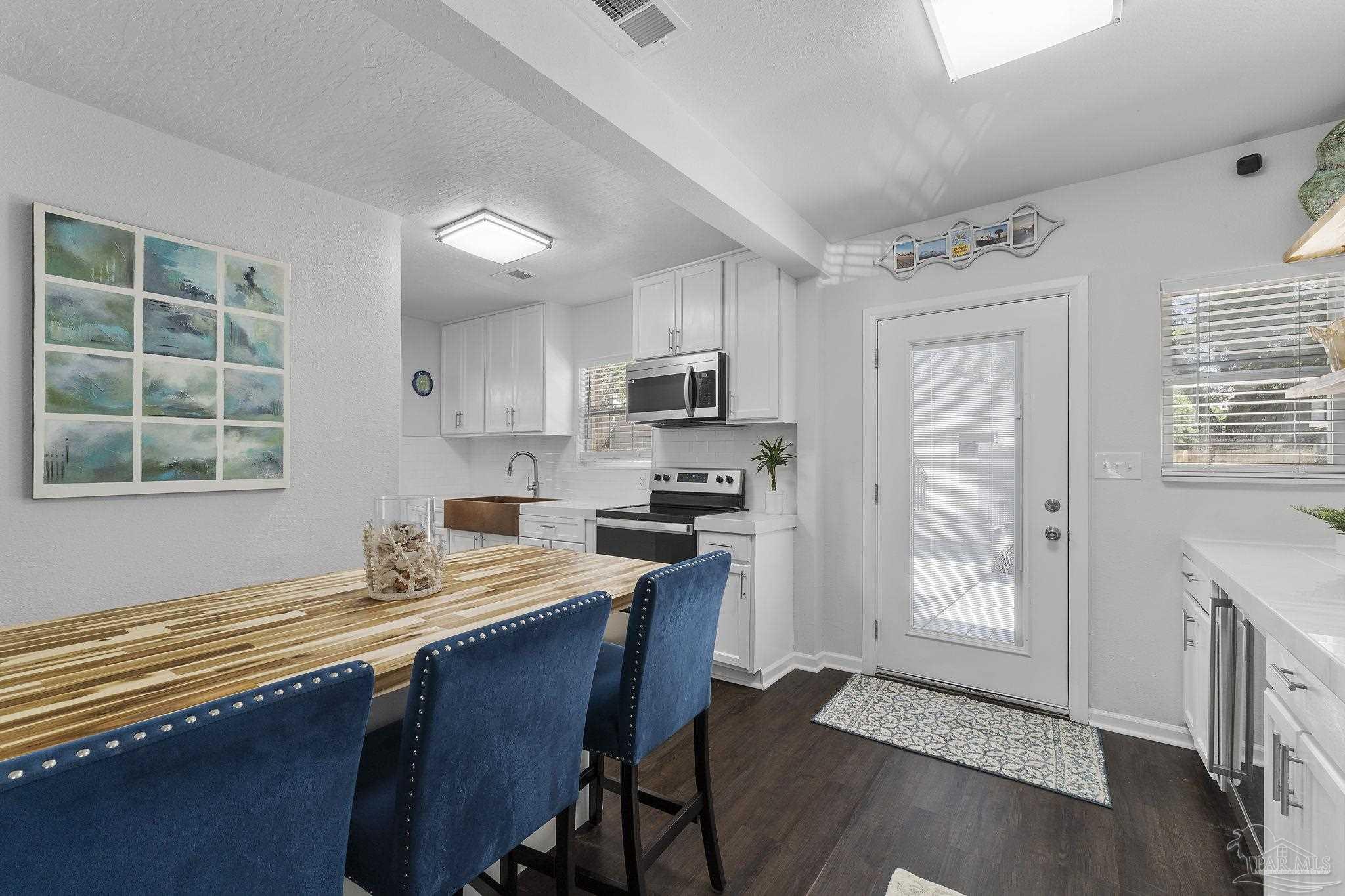 306 South N Street Pensacola, FL 32502 - Photo 32 of 37 a kitchen with granite countertop a stove cabinets and wooden floor