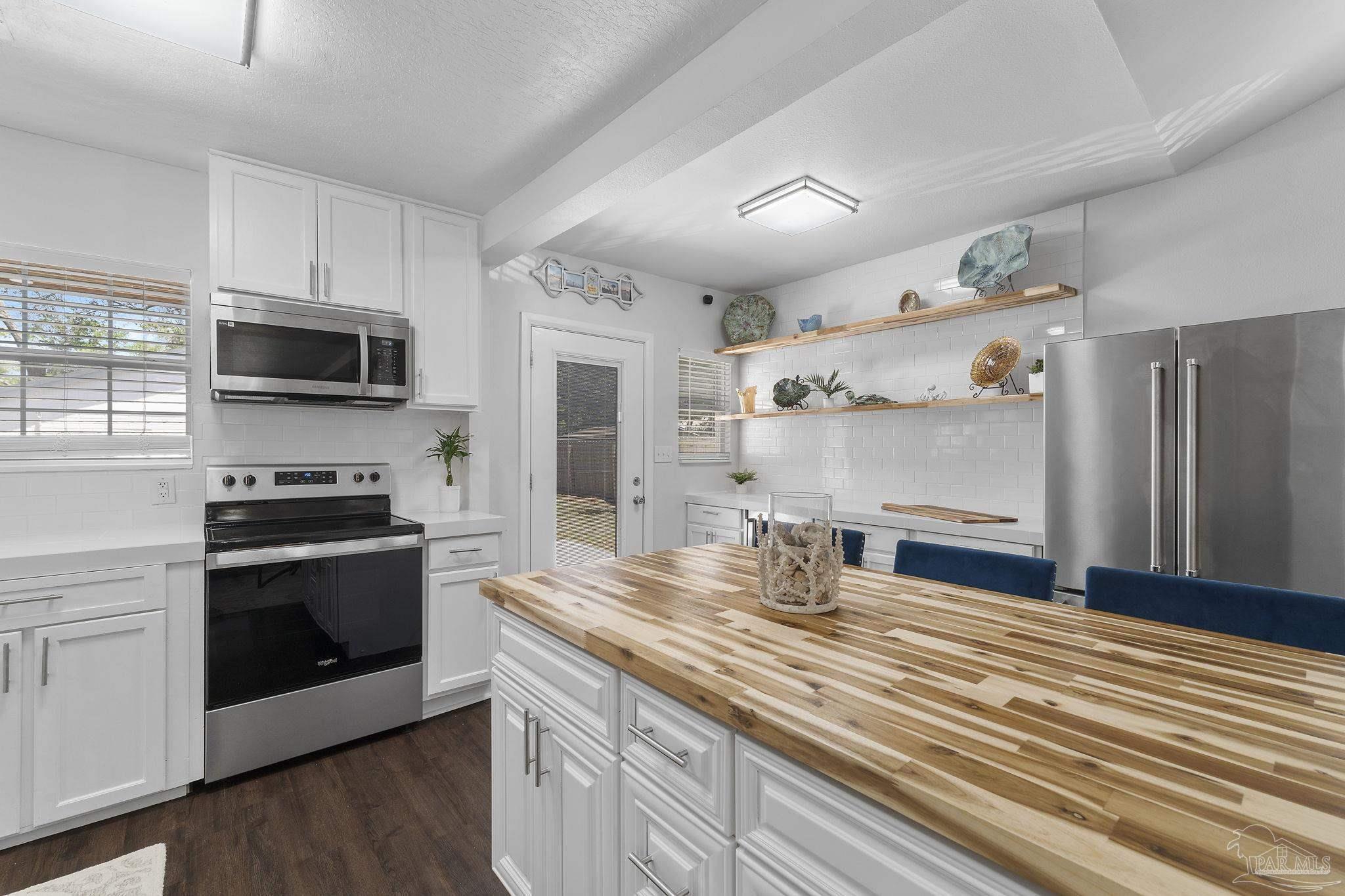 306 South N Street Pensacola, FL 32502 - Photo 33 of 37 a kitchen with stainless steel appliances kitchen island granite countertop a stove and a sink