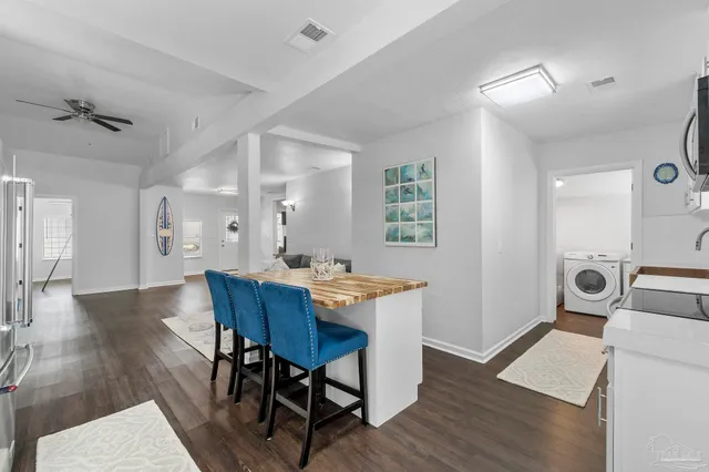 a large kitchen with a table and chairs