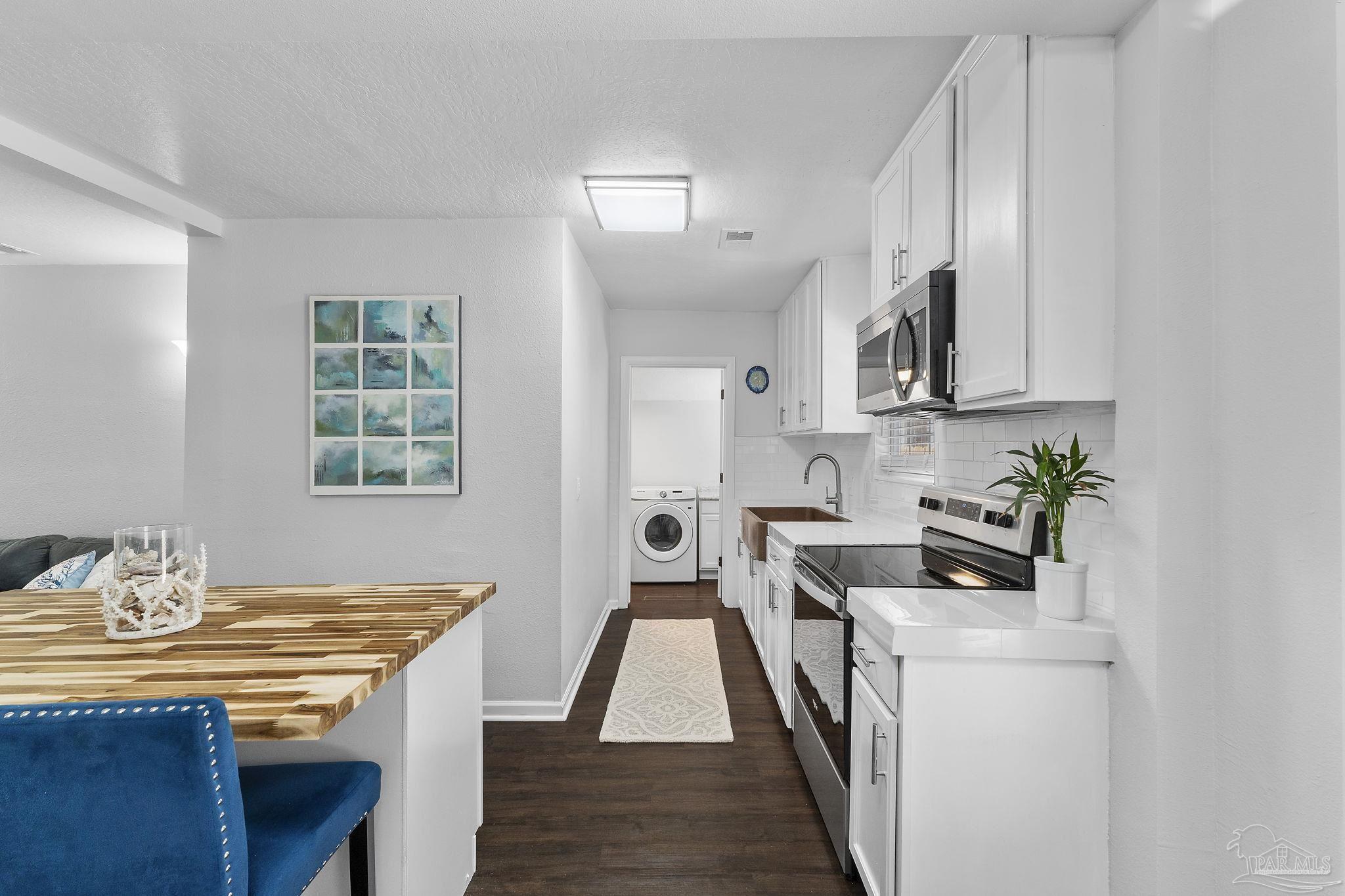 306 South N Street Pensacola, FL 32502 - Photo 37 of 37 a kitchen with stainless steel appliances granite countertop a stove a sink and a refrigerator