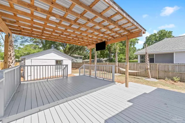 a view of a backyard with a deck and wooden floor