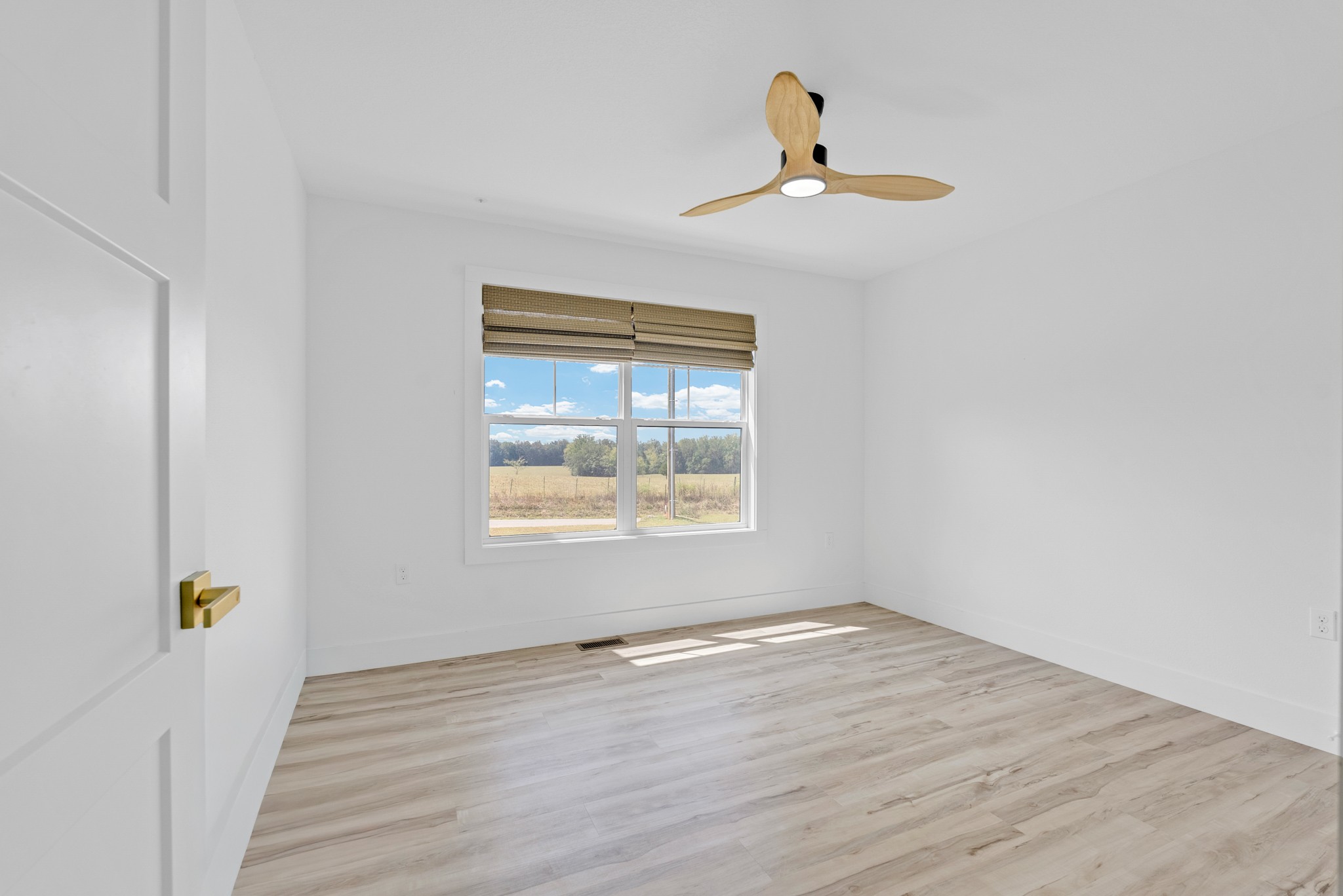 4733 Window Cliff Road Baxter, TN 38544 - Photo 17 of 25 a view of an empty room with wooden floor and a window