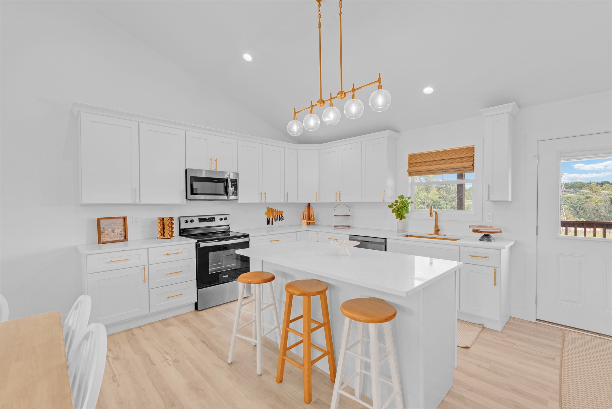 4733 Window Cliff Road Baxter, TN 38544 - Photo 5 of 25 a large kitchen with stainless steel appliances kitchen island granite countertop a sink and cabinets