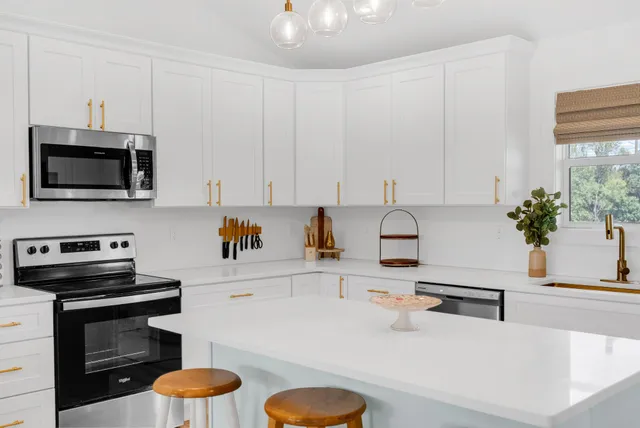 a kitchen with a sink a stove and a microwave