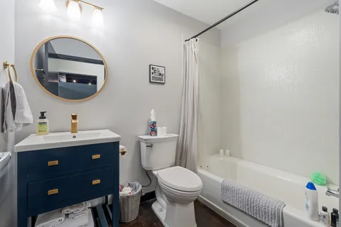 a bathroom with a toilet a sink and a mirror