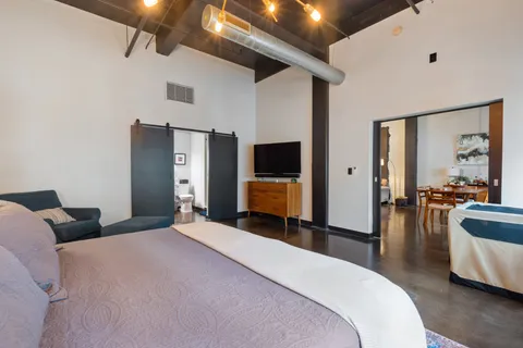 a bedroom with a large bed and furniture