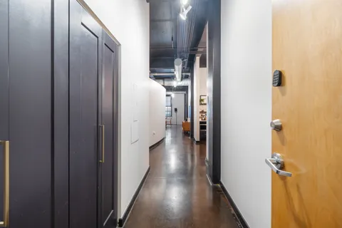 a view of a hallway with wooden floor