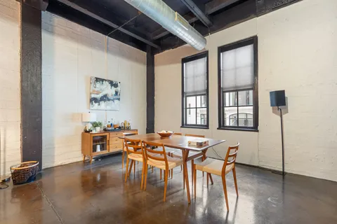 a dining room with furniture and wooden floor