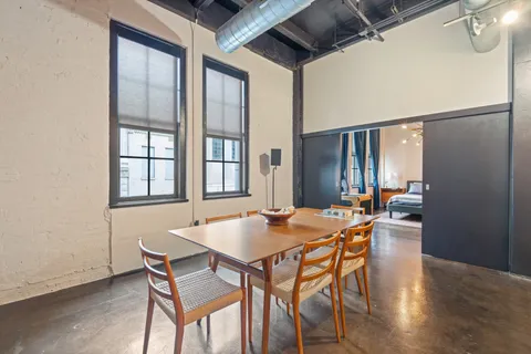 a dining room with furniture and window