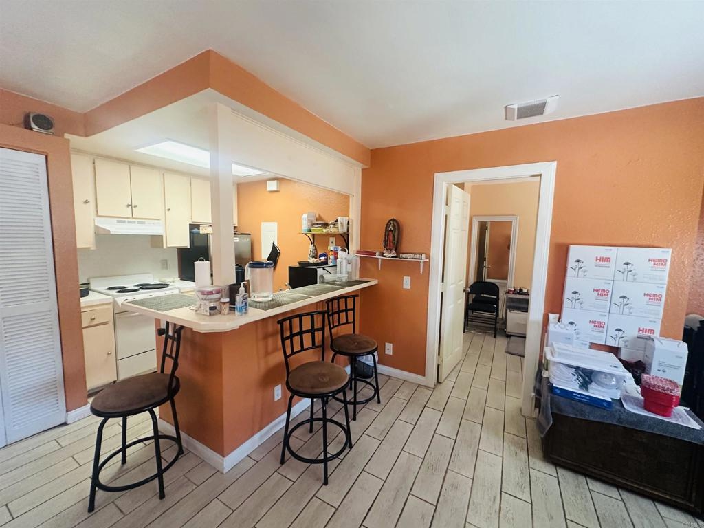 891 West San Ysidro Boulevard, Unit 9 San Ysidro, CA 92173 - Photo 1 of 18 a open dining room with stainless steel appliances kitchen island granite countertop a table chairs and a refrigerator