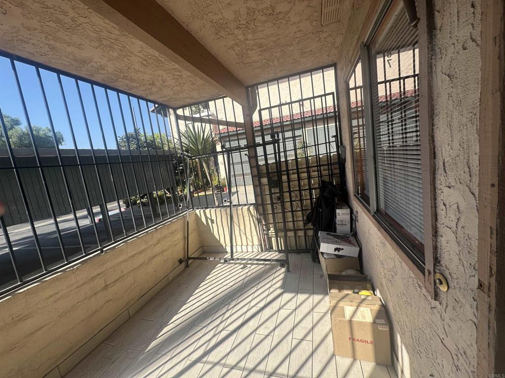 891 West San Ysidro Boulevard, Unit 9 San Ysidro, CA 92173 - Photo 13 of 18 a view of balcony with wooden floor