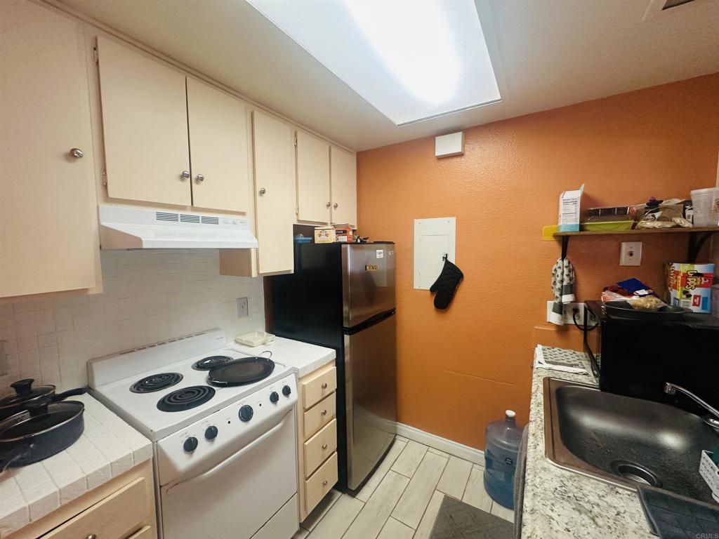 891 West San Ysidro Boulevard, Unit 9 San Ysidro, CA 92173 - Photo 18 of 18 a kitchen with a stove and a refrigerator
