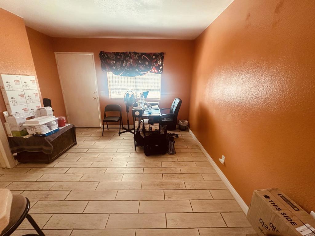 891 West San Ysidro Boulevard, Unit 9 San Ysidro, CA 92173 - Photo 4 of 18 a room with furniture and a large window